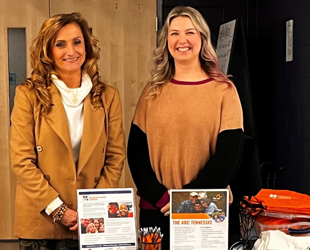 Photo of two women standing behind a table with information about the Tennesee Center for Decision-Making Support.